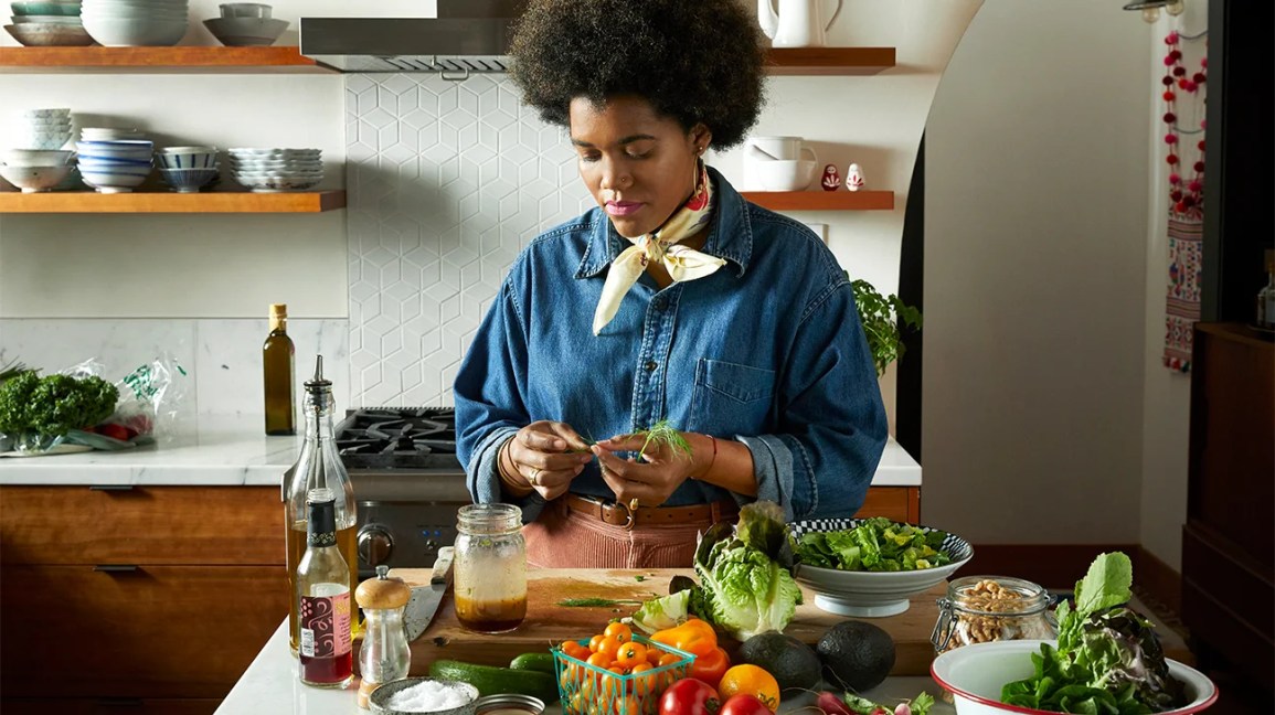 woman making salad with fresh vegetables