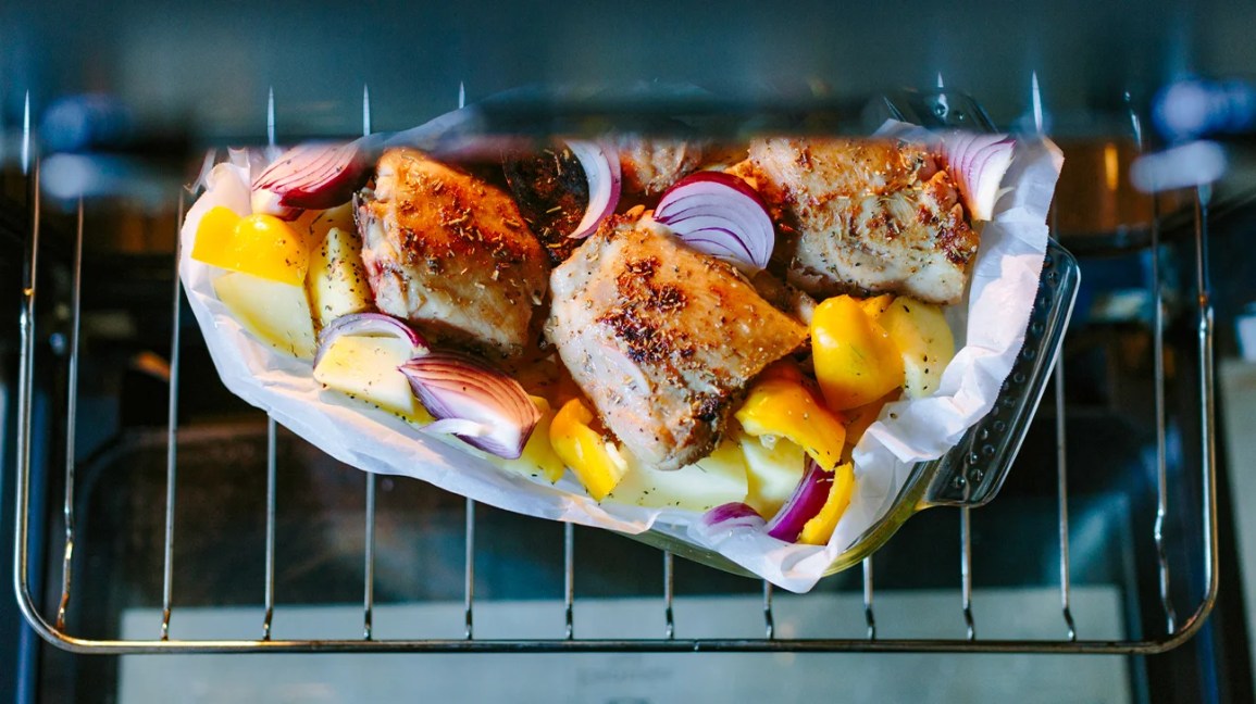 chicken and vegetables cooking on a grill