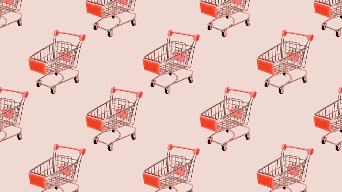 red shopping cart on pink background